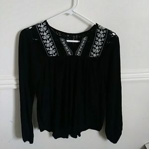 Black long sleeve shirt with white flower accent